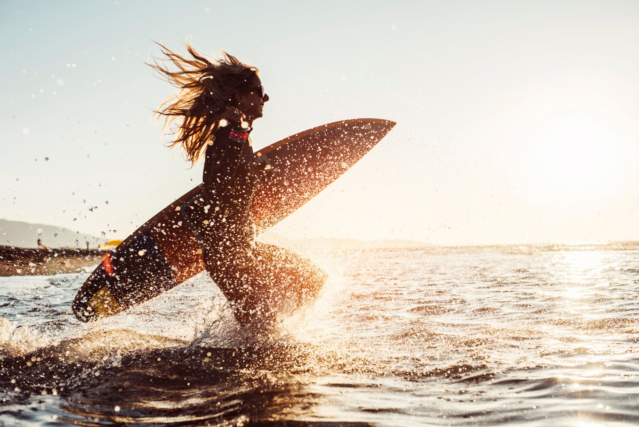 Woman preparing to surf